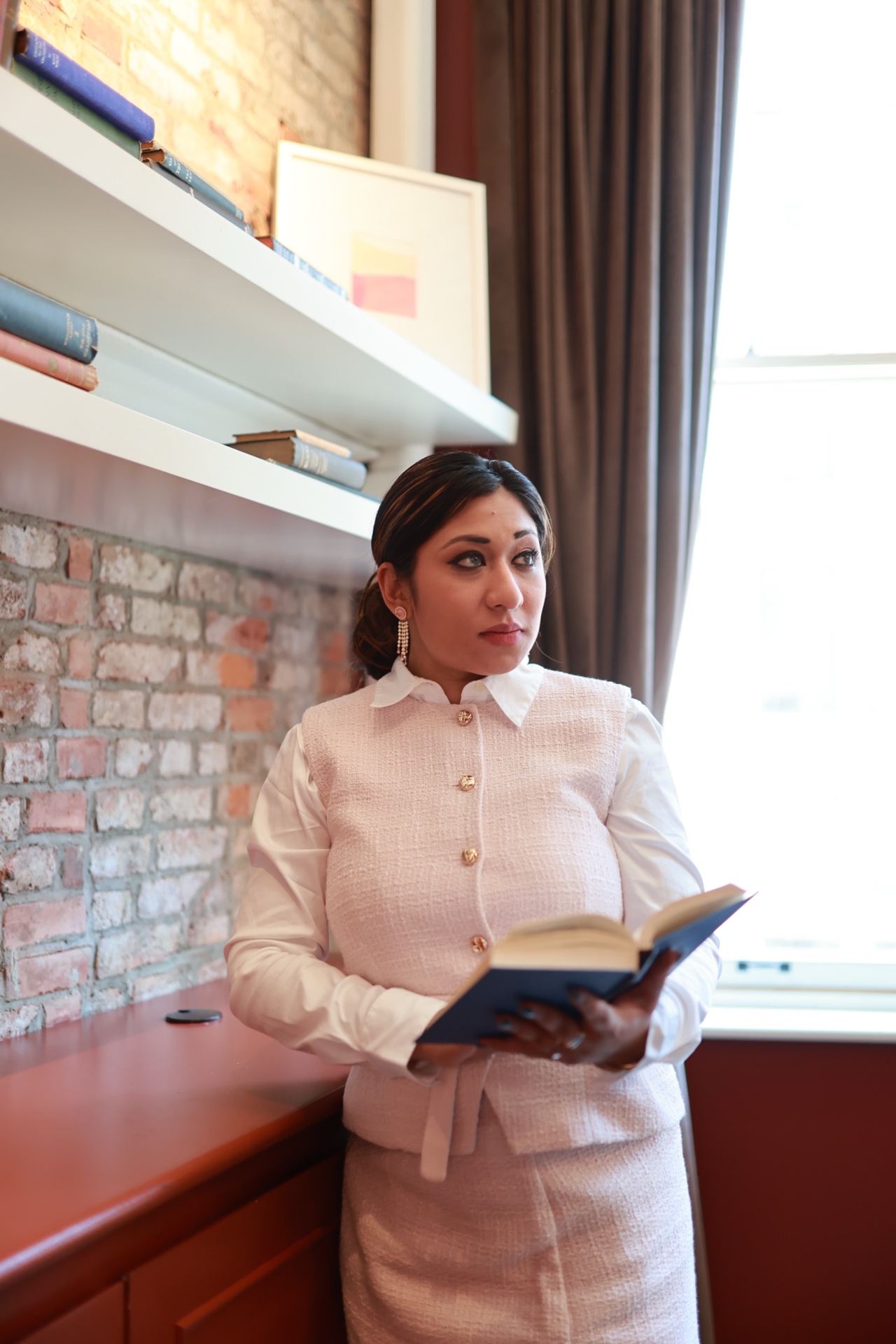 Mina Haque — holding book, confident