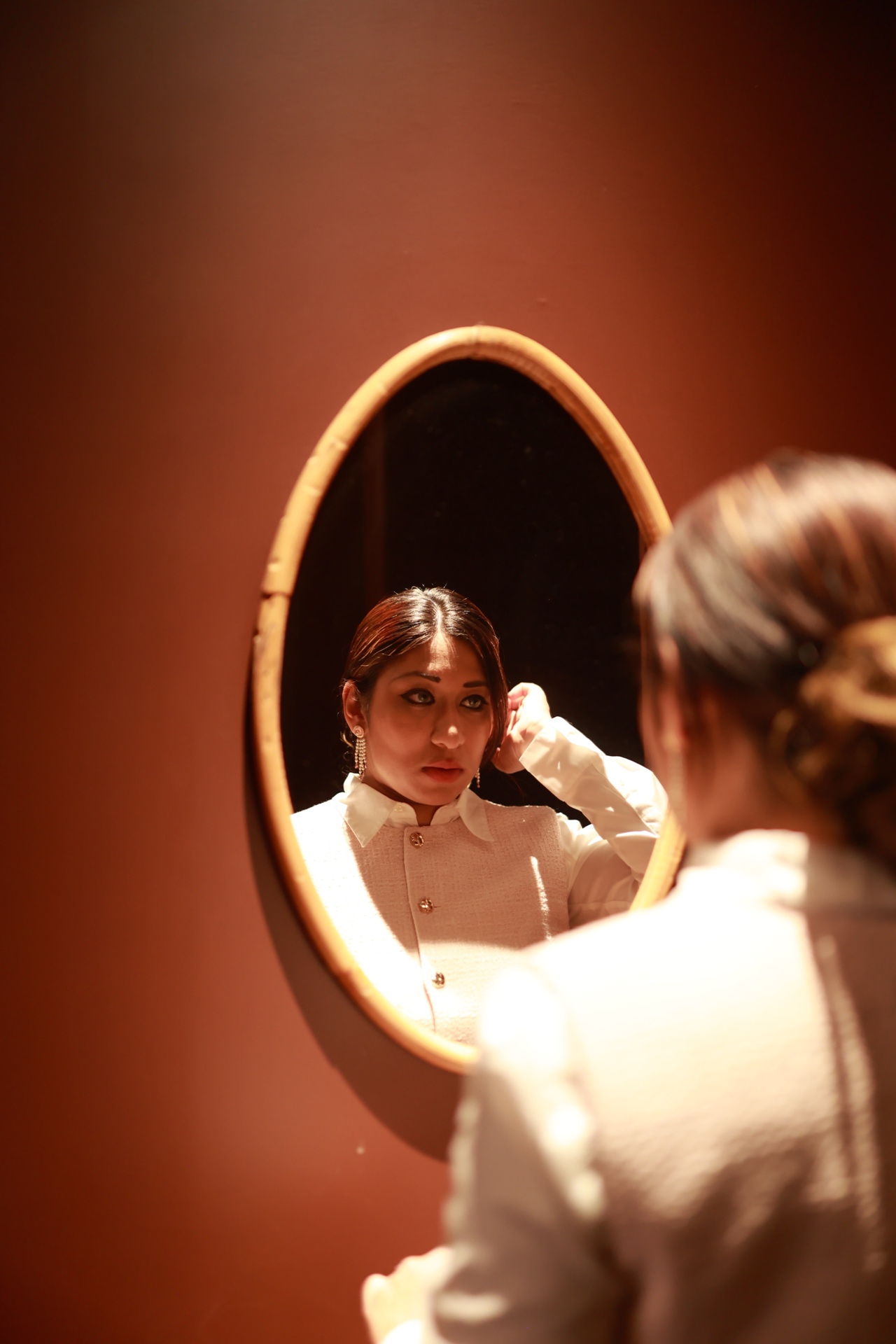 Mina Haque — mirror reflection, terracotta wall